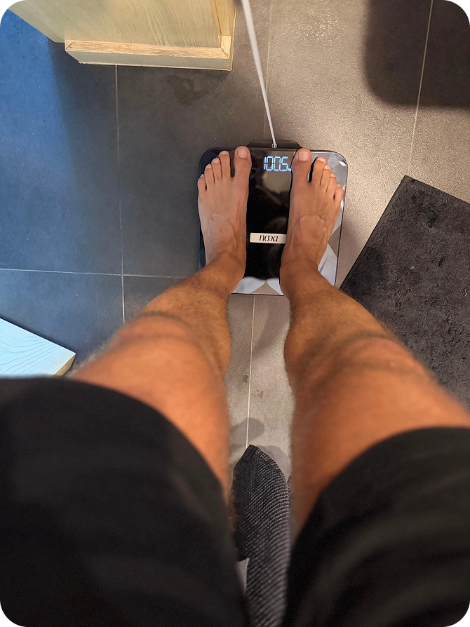 Man photographing himself in a hallway mirror, phone in hand
