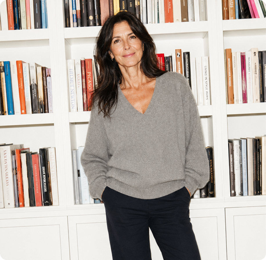Woman in her fifties standing in front of a bookcase