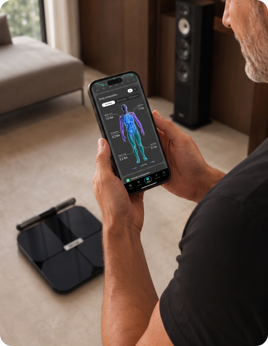 A man holding a phone showing the NOOA app body-composition scan